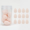 Macro detail of twelve pink teardrop beauty blenders with a clear storage canister - 12Pcs Jar Nude
