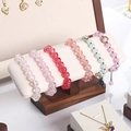 Walnut jewelry display stand showcasing assorted colorful cracked texture beaded bracelets - Walnut White 02