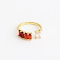 Dettaglio dell'anello dorato con quattro gemme rosse e una bianca di forma rettangolare - Aperto Regolabile / Rosso