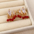 Close-up of vintage gold tassel earrings with red beads and marquise crystals - Rice Round Tassel Style