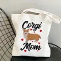 White canvas tote bag featuring Corgi Mom illustration with sturdy fabric handles - C7-Corgi Mom