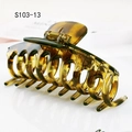 Detail of amber tortoiseshell large hair claw clip with glossy resin finish and metal spring - Transparent Amber