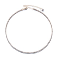 Close-up of gold plated tennis necklace with lobster clasp and adjustable chain tail - White Rhinestone (With Drop Charm)