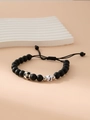 Matte black beaded bracelet with soccer charm and letter J on white display stand - Letter J