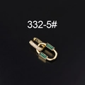 Macro shot of interlocking gold rings with green crystals and white zircon stones - Gold Green Zirconia Chain Style (332-5#)