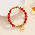 Elastic beaded bracelet with red beads, gold accents and a lucky four leaf clover charm - Red Beads-Gold Clover Charm
