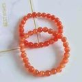 Vibrant orange cat eye beaded bracelet with 8mm round stones on a gift display card - Red Cat's Eye