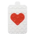 Detail of a rectangular silicone phone suction mat with a red heart design on white surface - White + Red