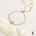 Close-up of 18K gold adjustable slider bracelet with sparkling round zircon center - Round Main Stone Style
