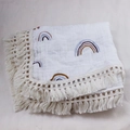 Detail of soft cotton baby blanket featuring rainbow print and delicate tassel edges - 80x65cm / Rainbow