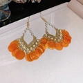 Detail view of orange floral shell pendant earrings with pearls on beige velvet tray - Orange Shell Pearl Earrings (Ear Hook)