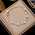 Detailed shot of a gold stainless steel bracelet with five white pearls on a gift box - Gold Stainless Steel with 5 Pearls