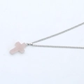 Macro shot of silver chain with translucent pink crystal cross pendant on white background - Light Pink