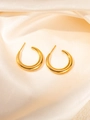 Polished gold-plated C-shape hoop earrings on elegant champagne silk fabric background - Gold Minimalist C-Shape Hoop Earrings