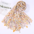 Detailed close-up of beach shawl featuring red and yellow floral patterns with small tassels - Style 18