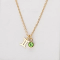 Gold Gemini zodiac necklace featuring a green emerald pendant on a stainless steel chain - Gold-Gemini