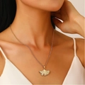 Golden ginkgo leaf pendant necklace worn by model for an elegant autumn jewelry style - Gold Ginkgo Leaf Necklace (10531)