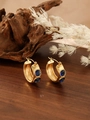 Close-up of golden hoop earrings with dual blue square zircon stones on wooden background - ZHE986 Style - Blue Rhinestone / 18K Gold