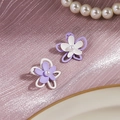 Floral stud earrings with purple and white layers and pearl center on pink fabric - Purple White Layered Pearl Flower Studs