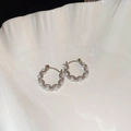 Silver wavy hoop earrings with small pearls on a white shell tray minimalist style - No 30 Silver Pearl Hoop
