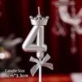 Silver number 4 birthday candle with mini crown and bow detail on red velvet background - Number Candles Silver Crown Bow 4