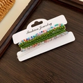 Detailed view of bohemian multilayer beaded bracelet set with star charms and diverse colors - 7-Piece Green Set
