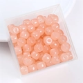 Top view of 8x6mm pink square glass barrel beads in a transparent storage box - Nude Pink