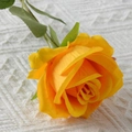 Realistic single stem artificial yellow velvet rose with green leaves on white fabric - Yellow