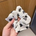 White scrunchie with black heart pattern in soft chiffon fabric held in hand - Black Heart