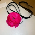 Detailed view of a large magenta lace fabric flower choker with long black satin ribbons - Rose Red