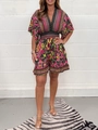 Detail of bohemian floral print V-neck romper with high waist and short sleeves - S / Top And Bottom / Black