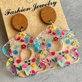 Macro view of floral pattern acrylic earrings with round wooden studs on craft card - Multicolor Small Flowers