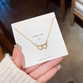 Collana dorata con doppio cuore intrecciato e pavé di zirconi su cartoncino regalo - Forma a Doppio Cuore Intrecciato (X252) / Oro