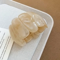 Close-up of cream marble texture acrylic chunky stretch bracelet on a textured tray - Off White