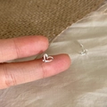 Minimalist silver heart stud earrings shown on fingertip for size reference - Mini Metal Heart Style (A289)