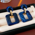 Macro detail of blue marble texture square earrings on a beige velvet jewelry pad - Blue (925 Silver Pin)