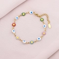 Detail of colorful enamel flowers and evil eye charms on a golden stainless steel bracelet - Evil Eye & Daisy