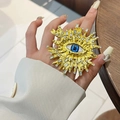 Close-up of golden Evil Eye ring featuring blue enamel and sparkling rhinestones - Sun Evil Eye Gold Ring