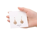 Golden snowflake earrings with sparkling white zircons on a white display card - 15mm Rose Gold Snowflake