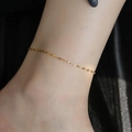 Minimalist golden titanium steel anklet on ankle with delicate shimmering link chain - B60 Lip Chain