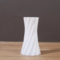 Minimalist white ceramic vase with spiral texture for home decor on a wooden surface - White