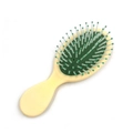 Mini oval cushion hairbrush with cream handle and green air cushion for scalp massage - Warm Yellow