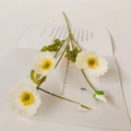 Elegant white artificial poppy flowers with three blooms and one bud on book - White