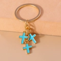 Detail of blue enamel cross pendants on a polished gold-tone metal keyring with charms - Blue