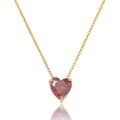 Detailed macro view of heart-cut red zircon pendant on a fine golden chain necklace - Necklace-Red