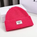 Detailed knit texture and patch of the magenta winter beanie on white display - 56-58cm / Pink