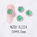 Macro detail of 10x9.5mm green cat-eye heart nail charms with silver rhinestone borders - Silver Base Emerald Green Opal (AJ24)