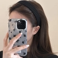 Close-up of a black knitted headband worn by a model for a stylish winter accessory look - Black