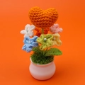 Handmade crochet orange heart potted plant with colorful flowers in a white ceramic base - Orange Heart