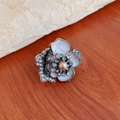 Macro detail of vintage floral ring with white enamel petals, pearl center and crystals - Purple Flower Ring